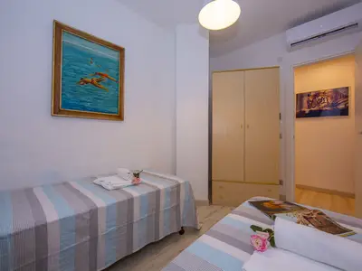 weites Schlafzimmer mit 2 Einzelbetten und Klimaanlage