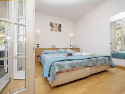 Schlafzimmer mit Doppelbett und Zugang zum Balkon