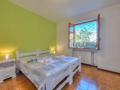 Zweibettzimmer mit Kommode, Kleiderschrank, Nachttischen und Lampen