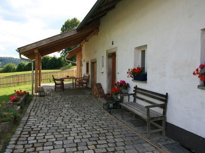 Überdachte Terrasse mit Holzmöbeln