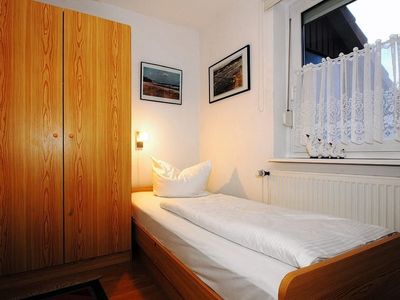 Schlafzimmer mit Einzelbett und Kleiderschrank