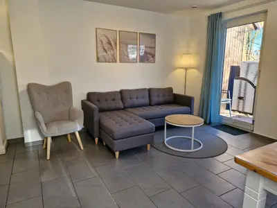 Wohnzimmer mit Sofaecke und Sessel