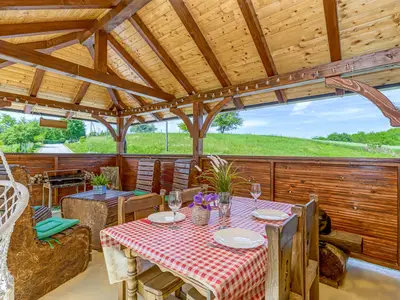 Überdachte Terrasse mit Tisch und Stühlen