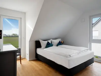 Ferienhaus Duncan House Blick in eines der Schlafzimmer mit Doppelbett