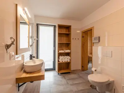 Badezimmer mit Dusche und Zugang Sauna
