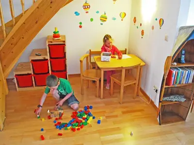 Kinder-Spielecke mit CD-Player, Spielzeug, Büchern und Malsachen.