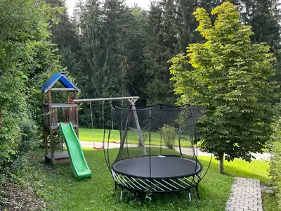 Trampolin, Sandkasten, Rutsche und Schaukeln im Garten