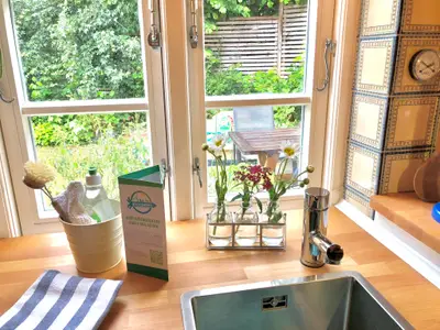 Küche mit Blick in den Garten und Kräuterbeet vor dem Fenster