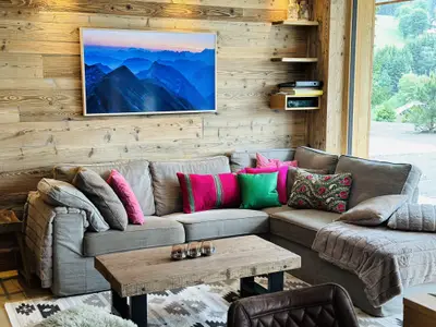 Couch with flatscreen, fireplace, panoramic windows