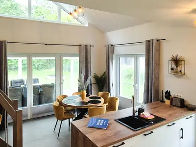 Moderne Küche mit Esstisch und großen Fenstern