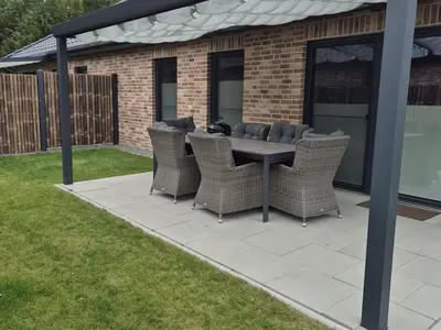 Überdachte Terrasse mit Gartenmöbeln
