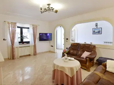 Das Wohnzimmer mit Sofa und TV