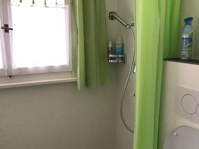 Kleines Badezimmer mit Bodenheizung. Dusche, Waschtisch, WC