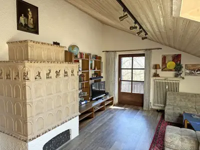 Wohnraum mit Elektrokachelofen und Südbalkon