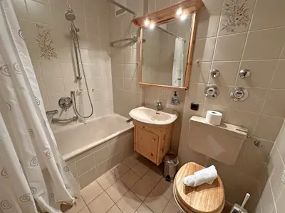 Badezimmer mit Badewanne und WC