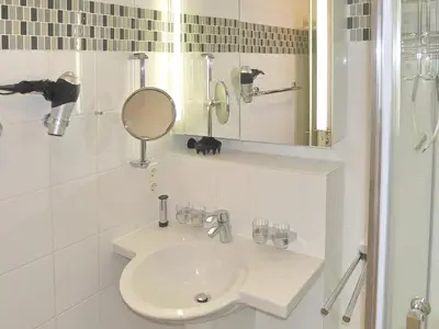 Badezimmer mit Waschbecken, Spiegel und WC