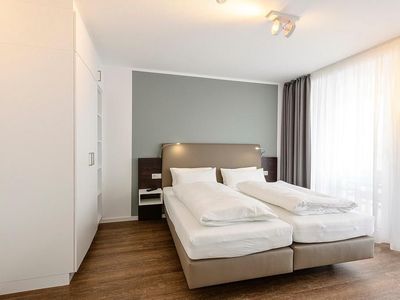 Schlafzimmer mit Doppelbett und Kleiderschrank