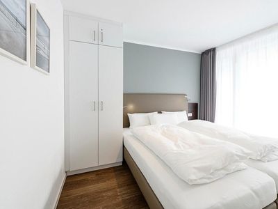 Schlafzimmer mit Doppelbett und Kleiderschrank