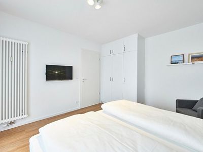 Schlafzimmer mit Doppelbett, Kleiderschrank und Flatscreen TV