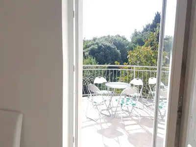 Balkon. Ein großer Balkon von Bäumen umgeben,Hinter den Bäumen sind schöne Strände