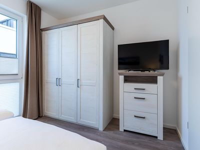 Schlafzimmer mit TV und Kleiderschrank