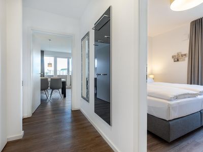 Flur mit Garderobe und Blick zum Schlafzimmer sowie Wohn-/Essbereich