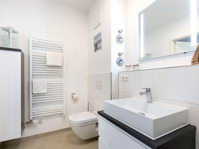 Badezimmer mit Waschtisch, Spiegel und WC