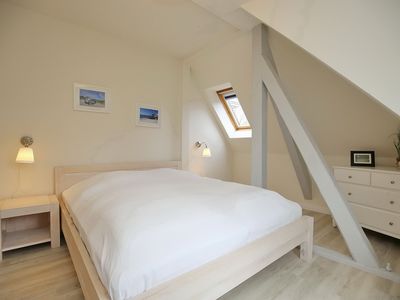 erstes Schlafzimmer mit Doppelbett und Komode