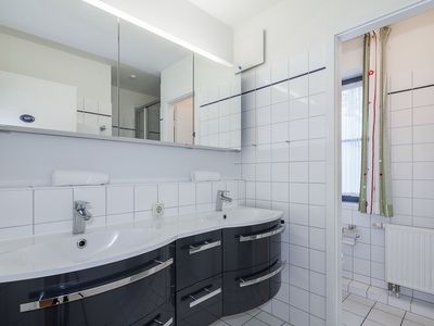 Badezimmer mit doppeltem Waschbecken und separatem WC