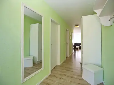 Eingangsbereich mit Schrank und Blick zum Wohnzimmer