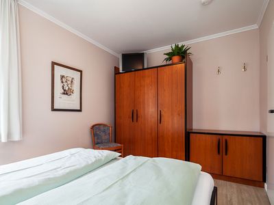 Schlafzimmer mit Doppelbett und Kleiderschrank