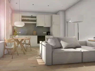 Blick von der Eingangstür zur Küchenzeile, zu sehen sind das Sofa und der Esstisch mit Stühlen.