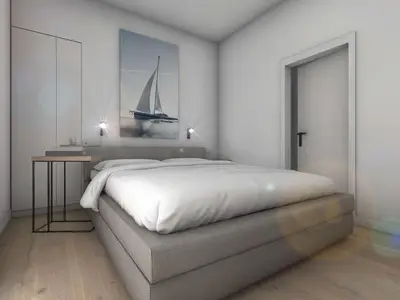 Blick von der Tür auf das Schlafzimmer mit Bett und Schrank.