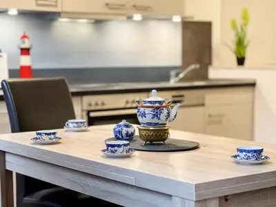Esstisch mit Blick auf Küche, Tisch ist mit Teegeschirr gedeck