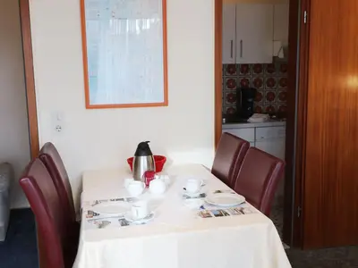Wohnzimmer mit Esstisch, anliegende Küche