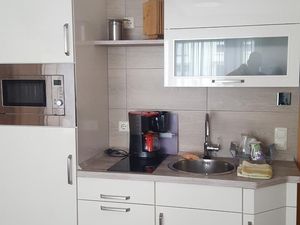 kleine Küche mit Kühlschrank und Kochplatten