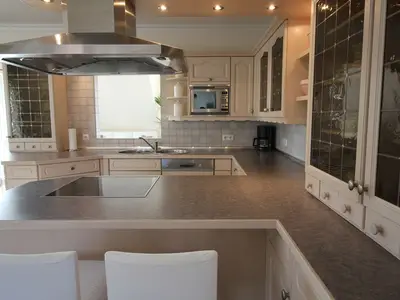 HAMPTONS HOUSE: Moderne Küche mit großzügiger Arbeitsfläche für entspannte Kochabende.