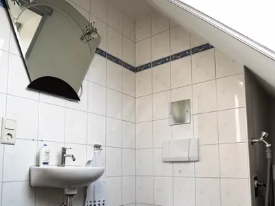 Das Badezimmer im Spitzboden mit Waschbecken und WC