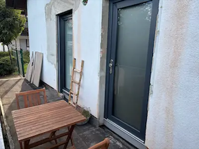 The outdoor area is still being completed, but the terrace can already be enjoyed with a small table and two chairs.