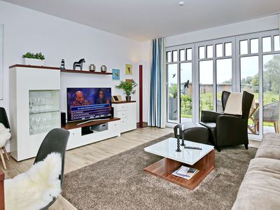 Wohnzimmer mit Sessel und TV