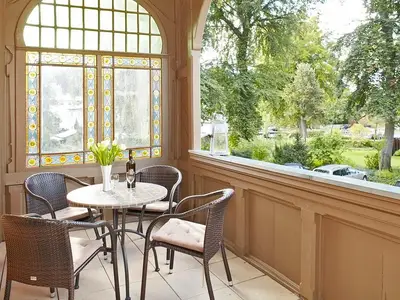 Überdachter Balkon mit Sitzgelegenheit