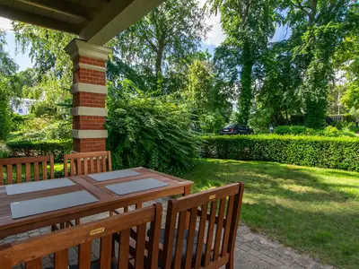 Überdachte Terrasse mit Gartenmöbeln