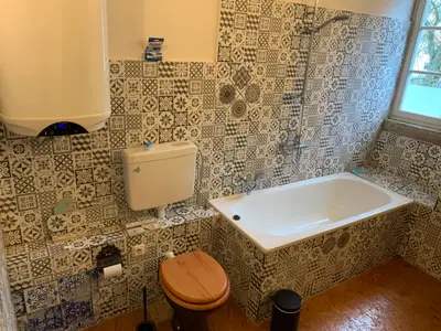 Badezimmer mit Wanne und Toilette