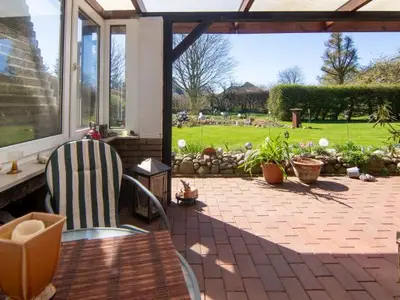 Garten und Wintergarten Ferienwohnung Hinterm Deich