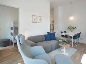Wohn-Essbereich mit Couch, Sessel und Esstisch