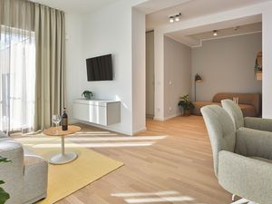 Wohn-Essbereich mit Flatscreen-TV und Blick in den Flur