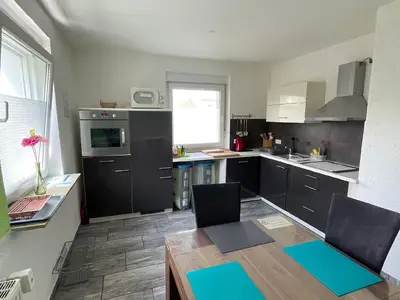Moderne Küche mit Esstisch und kompletter Ausstattung