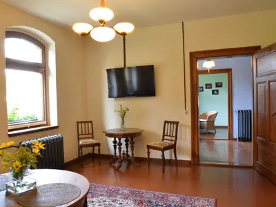Wohnzimmer mit Flachbildfernseher, Blick in die Küche und ins Esszimmer