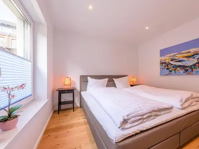 Ferienwohnung Inselzauber in Malchow eines der Schlafzimmer mit Doppelbett