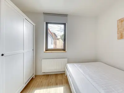 Ferienwohnung Family Suite Schlafzimmer mit Einzelbett